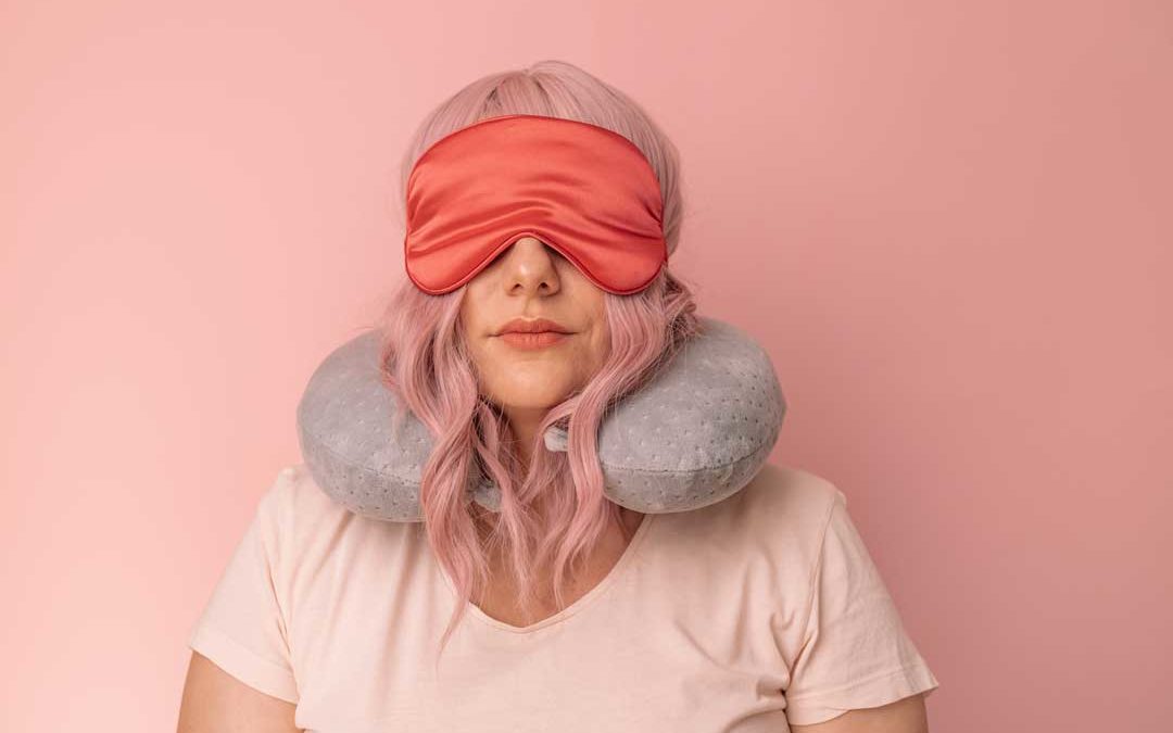 woman traveler in red sleep mask wants to sleep well