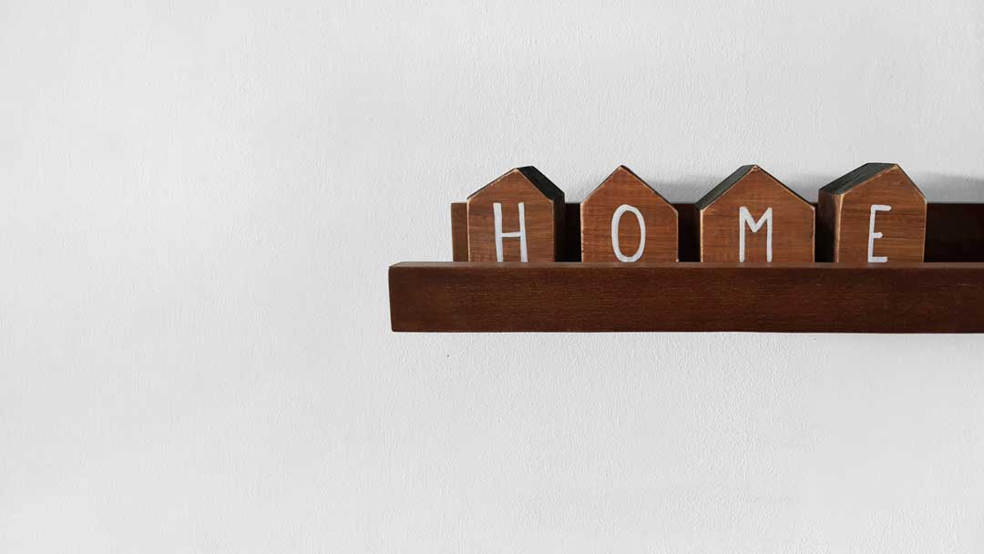 minimalist floating wooden shelf says home